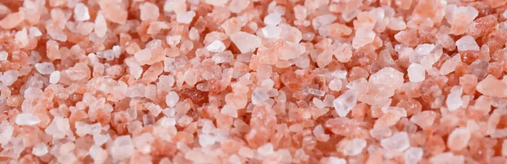 Close-up background texture of coarse pink Himalayan salt crystals