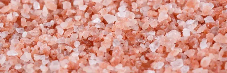 Close-up background texture of coarse pink Himalayan salt crystals