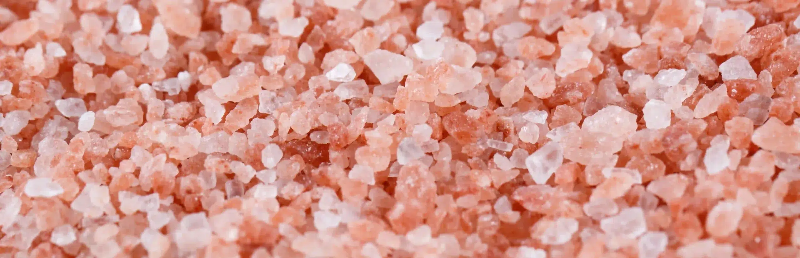 Close-up background texture of coarse pink Himalayan salt crystals